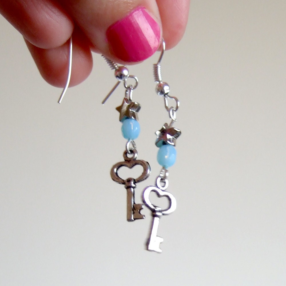 Small and very cute silver key earrings, with baby blue crystal and star bead