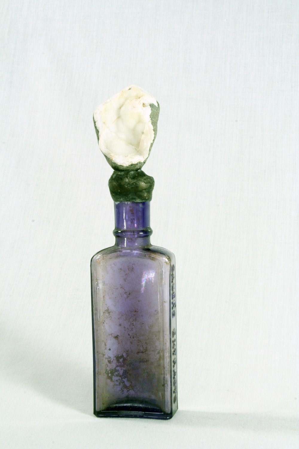 Vintage purple bottle with black stone white agate interior