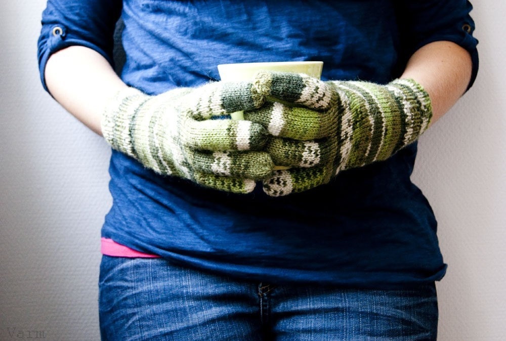 Hand knit wool blend gloves with green stripes.