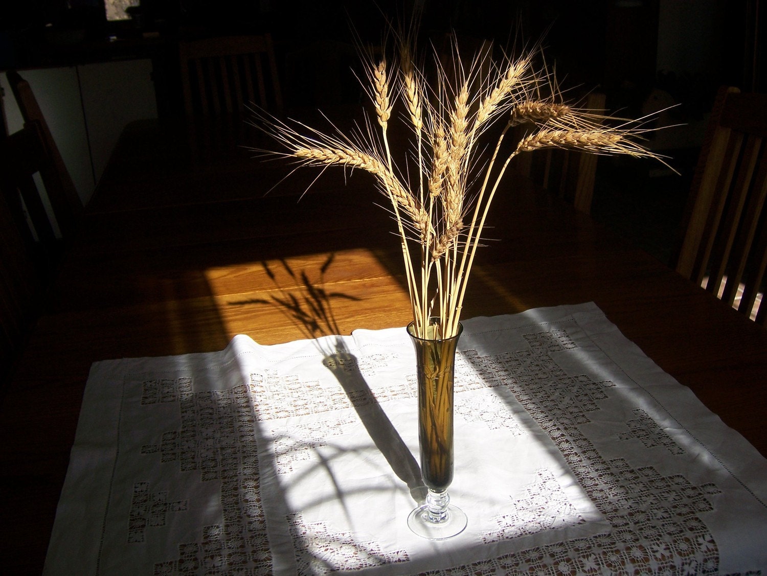 Glass vase with etched leaf pattern in smoky brown with hint of green and clear base. Simple elegance with Kansas wheat.