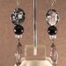 Long dangle earrings with round black beads with Mother of Pearl infused in beads, black and clear glass beads and smokey resin bead with b