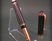 Hand cast carbon fiber and copper rollerball pen. Bold high tech looking pen.