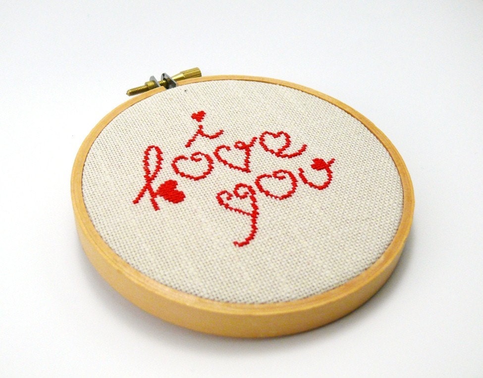 Cross stitch in wooden hoop I love you in red color