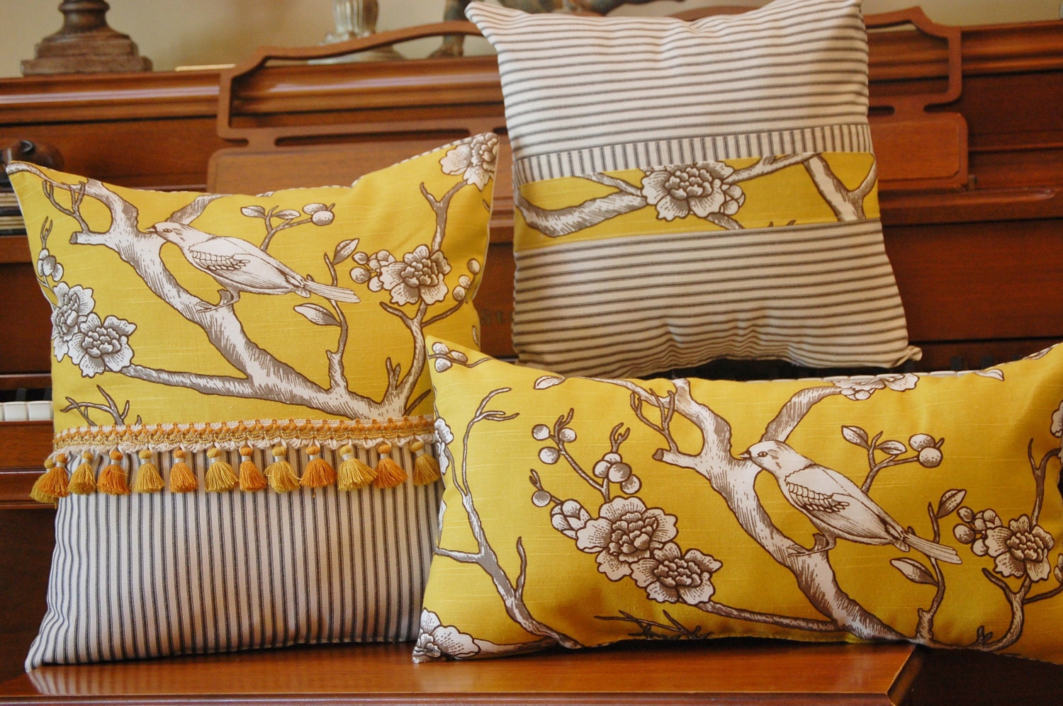 Yellow on black bird on a branch pillow collection