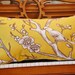 Yellow on black bird on a branch pillow collection