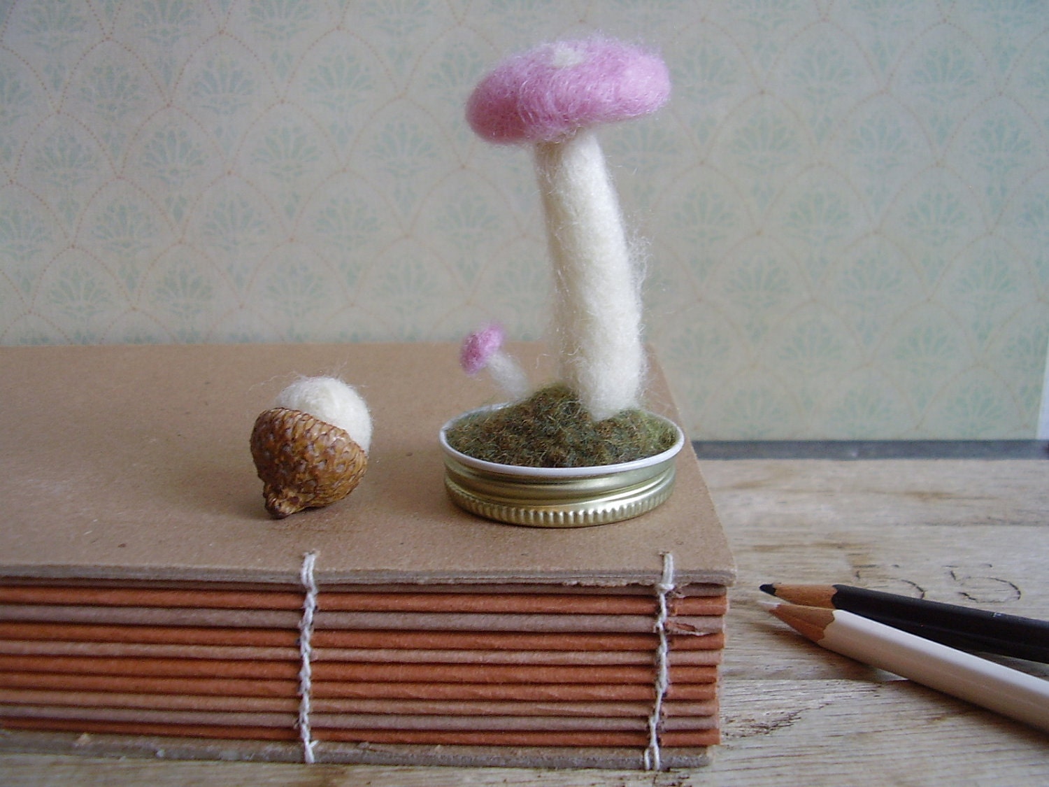 Felted wool garden, pastel pink amanita mushrooms in an upcycled lid