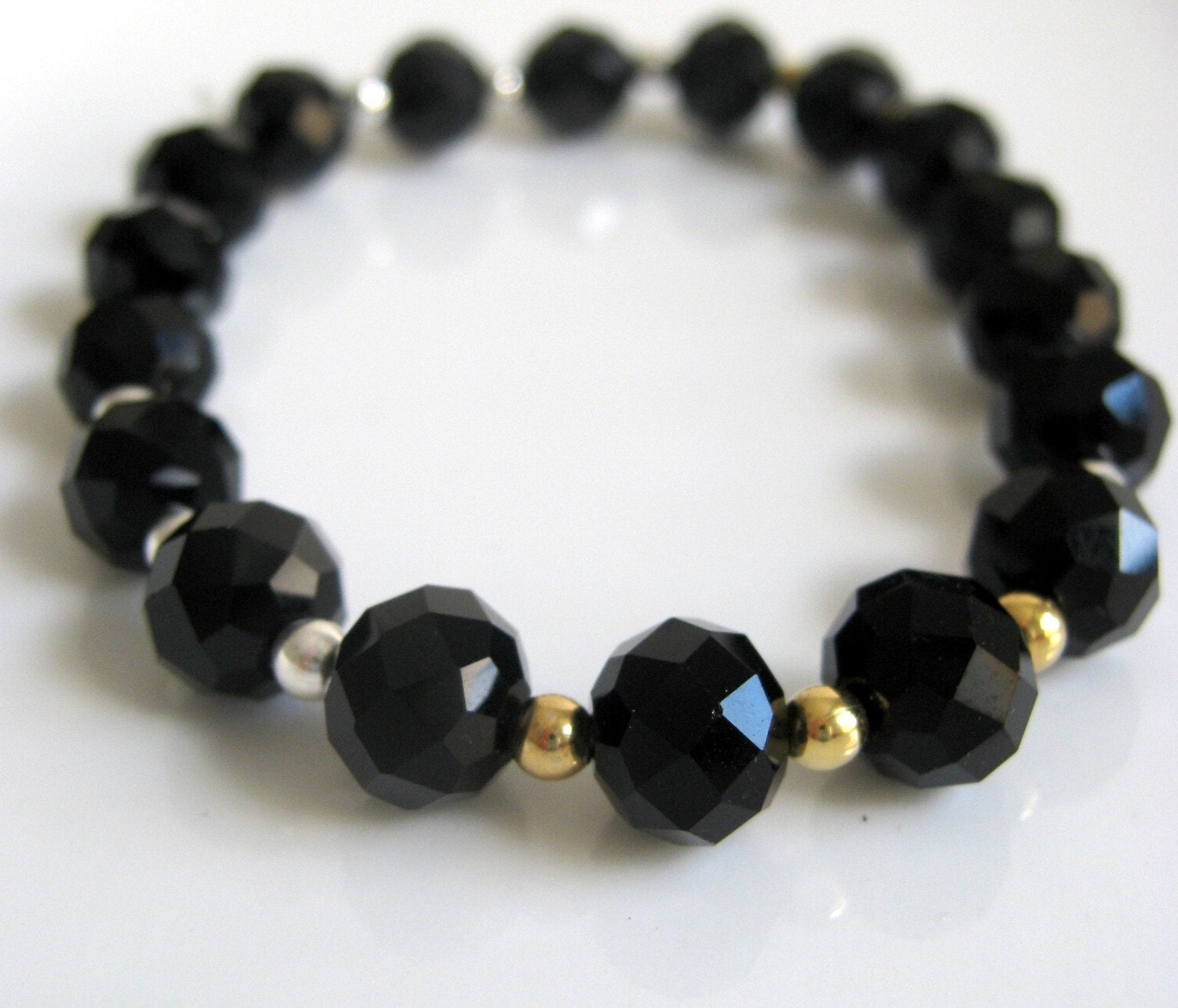 black crystal stretch bracelet with gold and silver accents