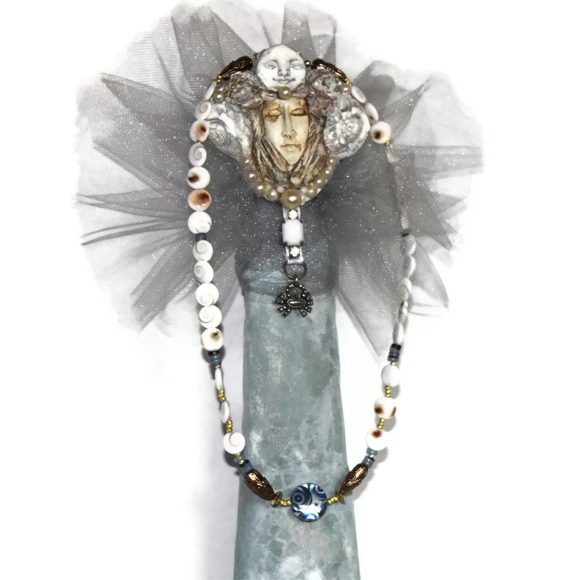 HOLDING for L's hubby - beaded necklace-decorative blue flat round shell- white brown Shiva eye disc- dark blue hammer shell Heische