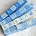BE HAPPY blue hand painted magnetic clothespin set