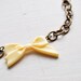 big beige bow -bracelet (pretty bow cabochon on a big linked bronze chain)