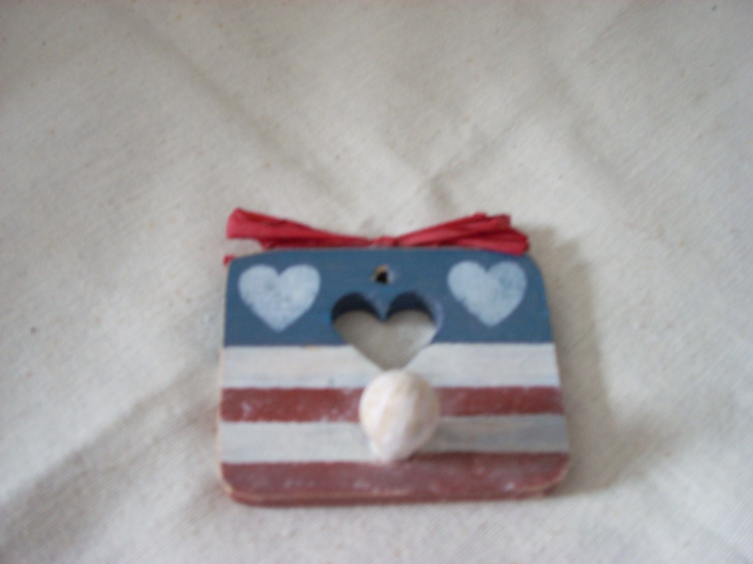 Three pieces of  Americana-- notepad, holder, pencil, wooden heart, hanging wooden heart