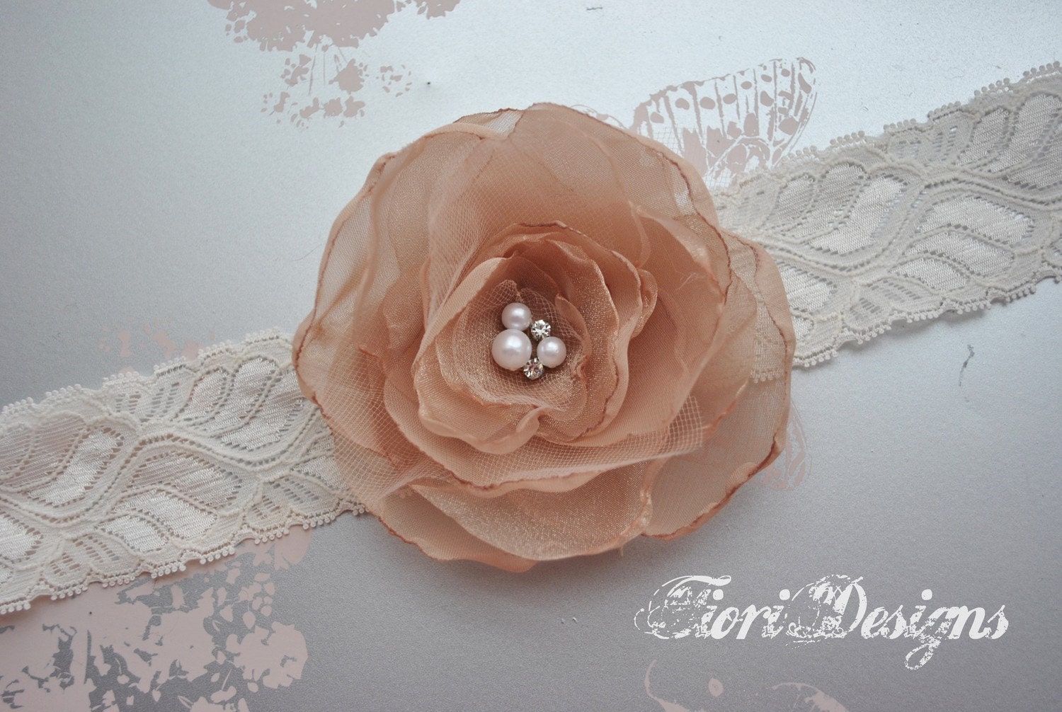 Gorgeous and full champagne flower with pearl and rhinestone center on a lace headband