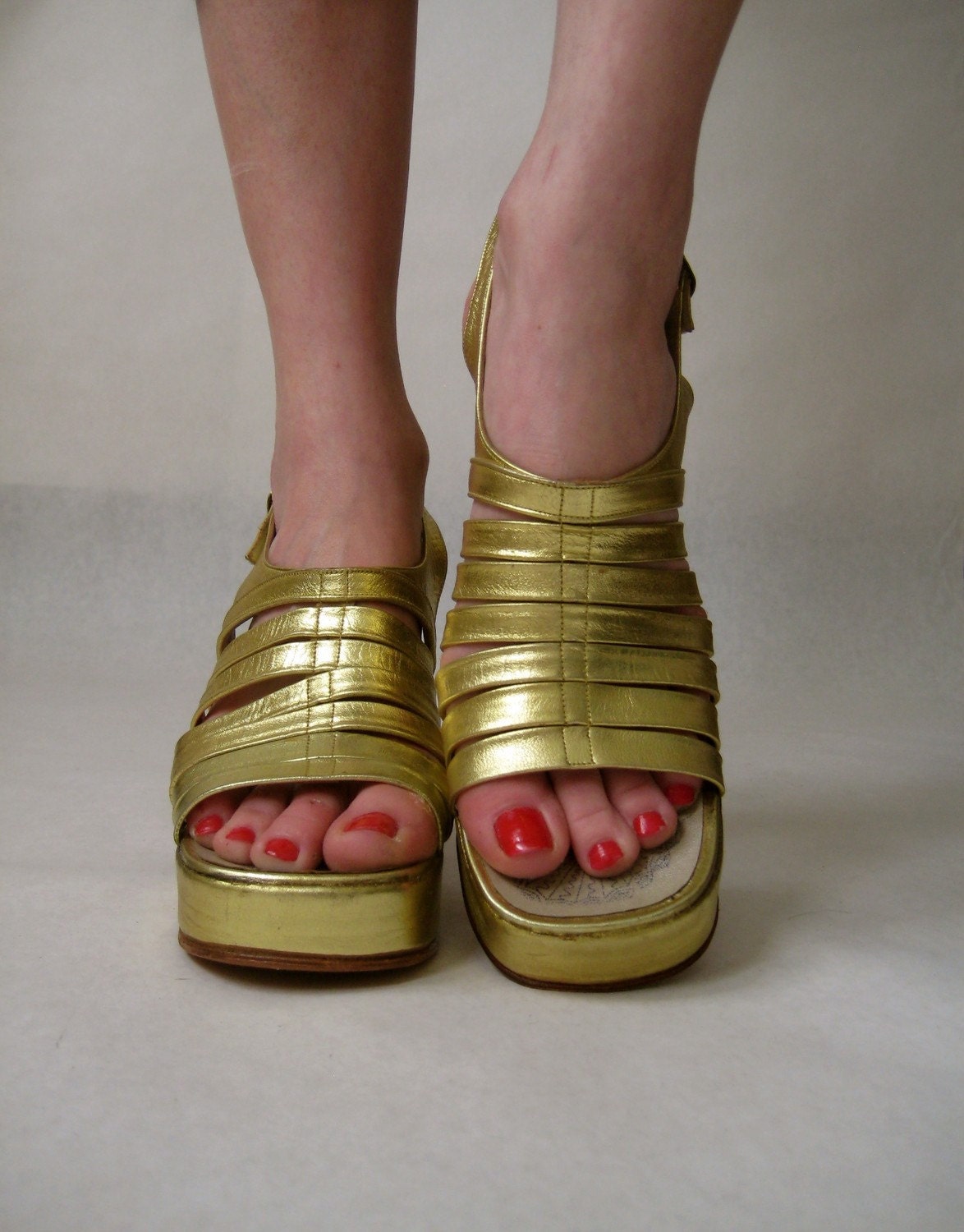 vintage 1970s platforms. metallic gold shoes. leather gladiator sandals. greek goddess glam high heels.