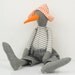Bird Doll - gray  duck  Wearing White & gray stripes Shirt , jeans  pants  And a white hat with orange dots - handmade