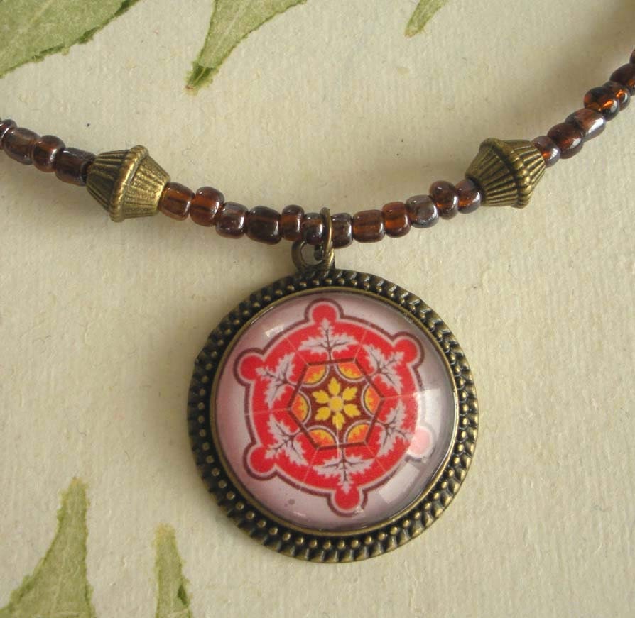 Spanish Tile Design Medallion in Red, Yellow & Pink on a Dark Plum Colored Beaded Necklace