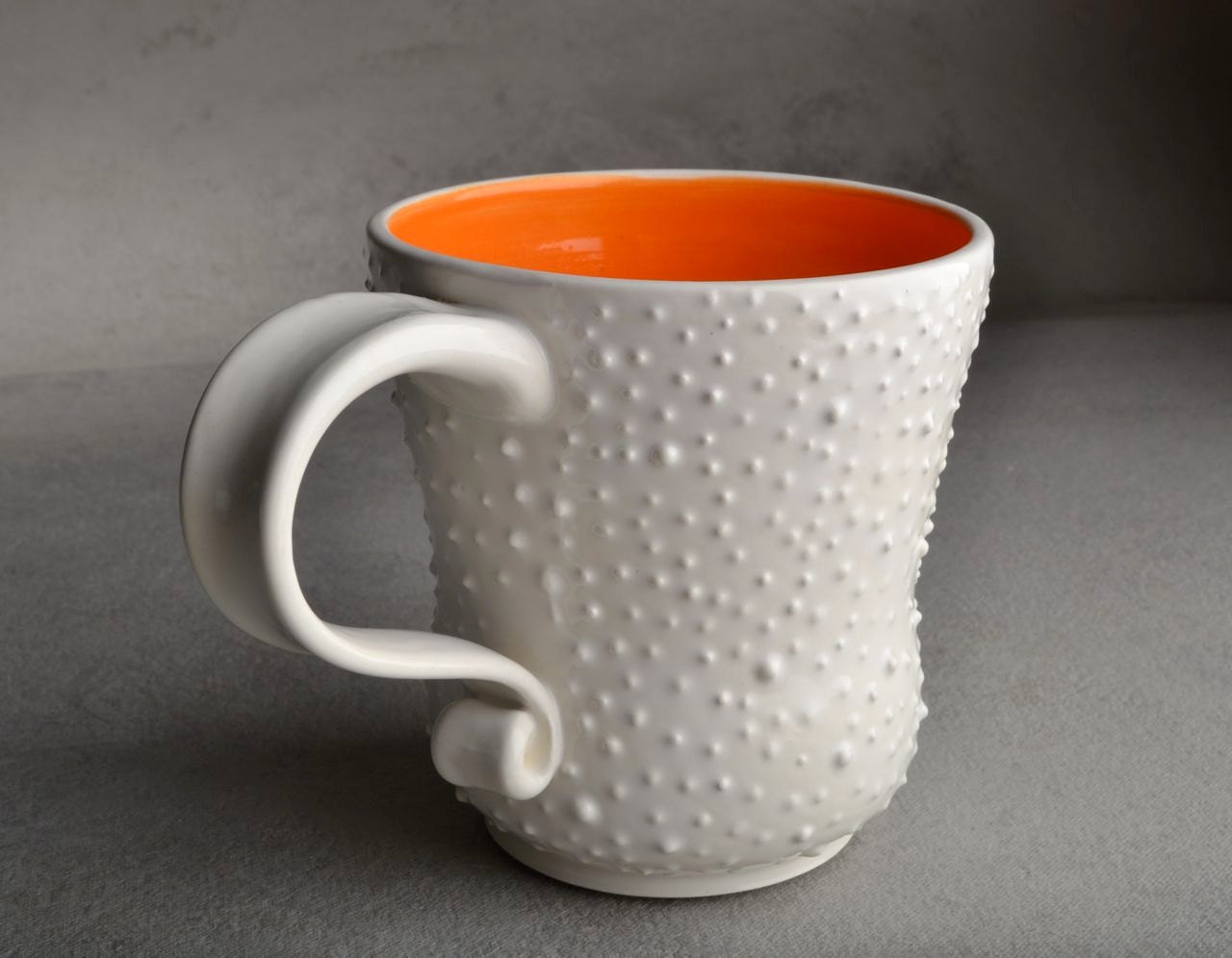 Dottie Mug: White With Orange Interior Dottie Mug by Symmetrical Pottery