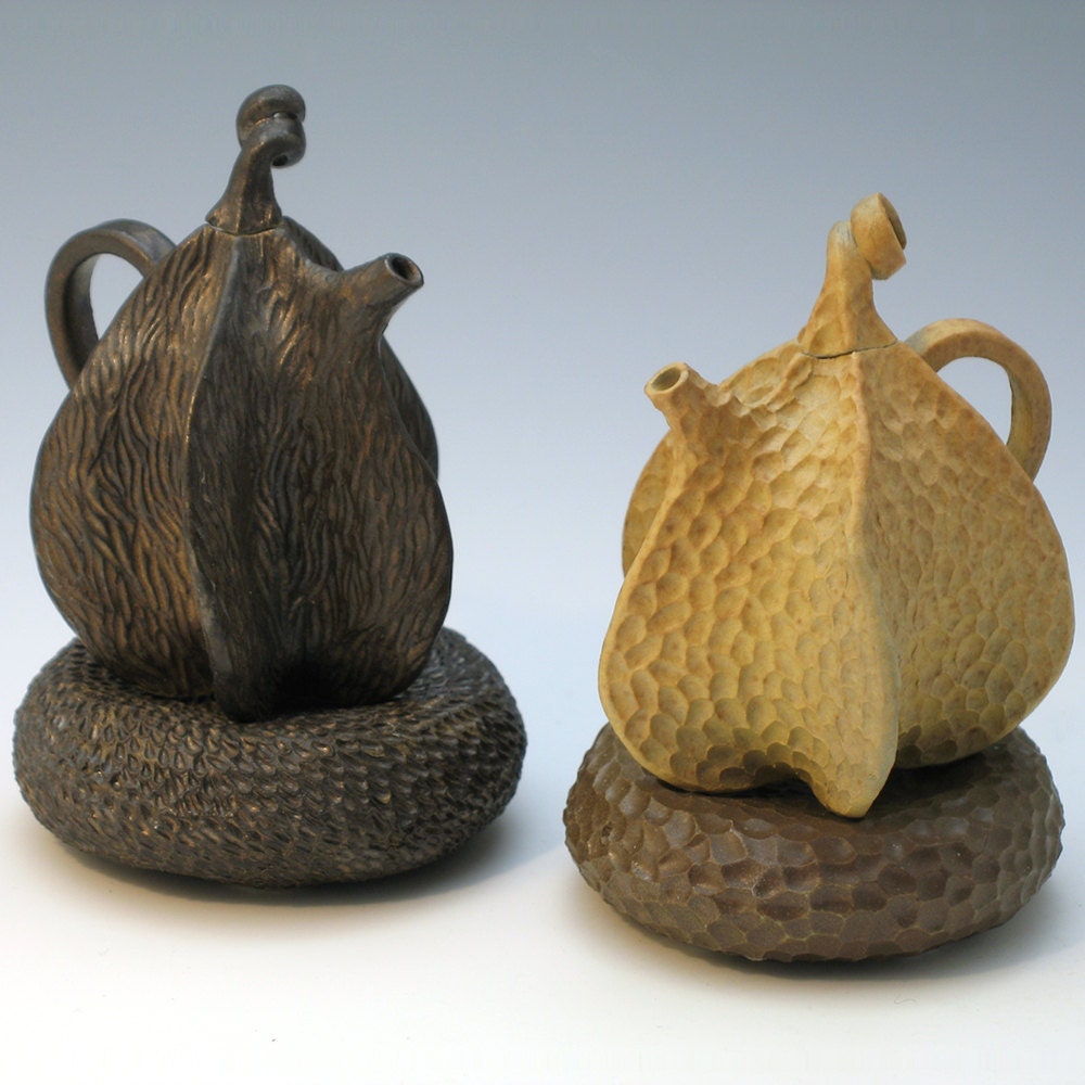 Porcelain teapot on brown pillow, hand carved, tan glaze