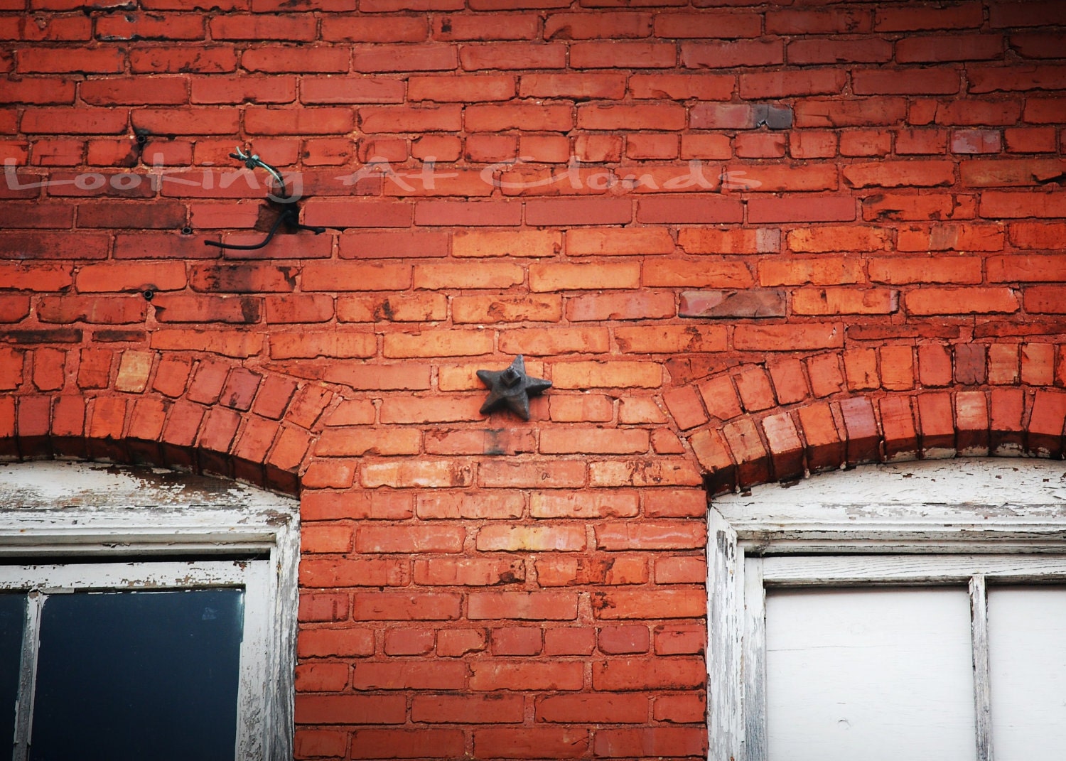 orange brick building with an iron star architectural element windows 5 x 7 fine art photograph