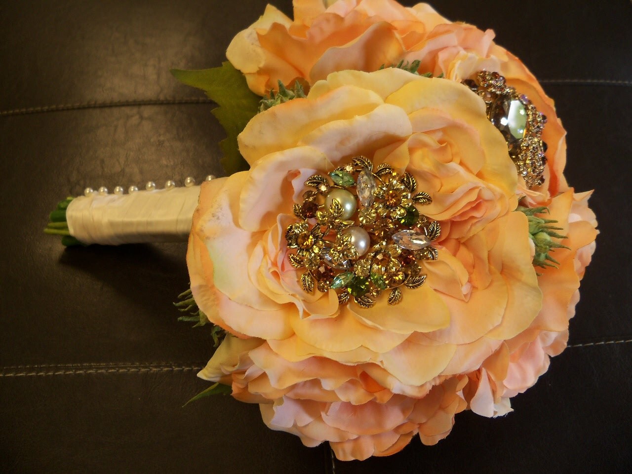 Peach/Coral Bridal Bouquet with Garden Roses and Ranuculus centered with Brooches