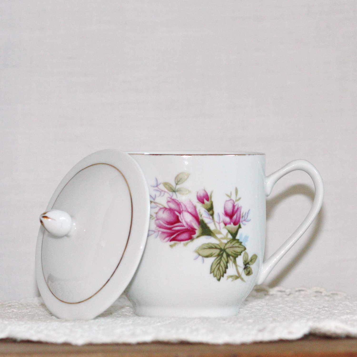 Vintage covered teacup in shabby chic pink roses
