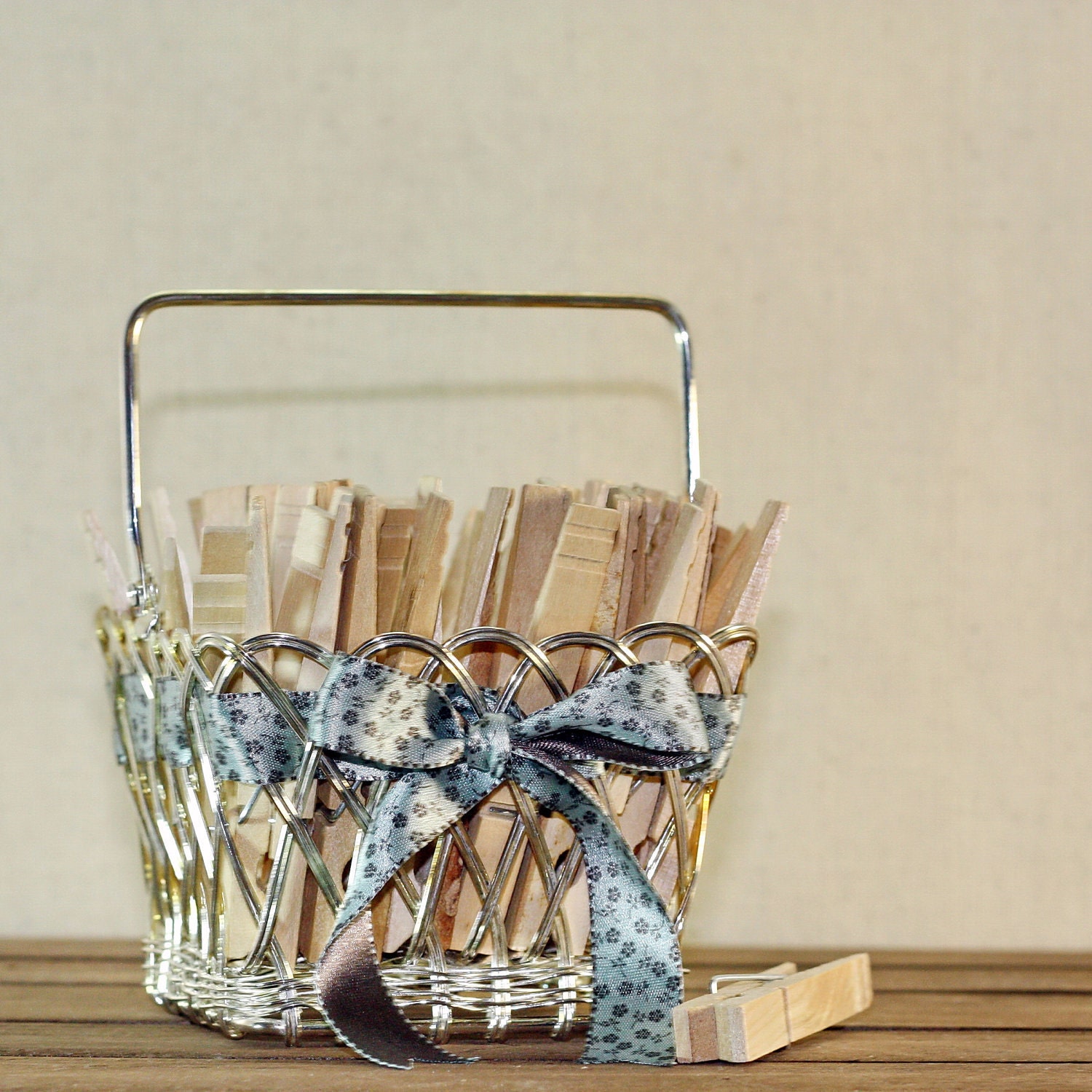 Vintage wooden clothespins in a silver strawberry basket