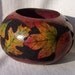 Large gourd bowl with wood burned and ink dyed fall leaves and dyed dot carved background. 1566.