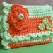 Light green and orange very practical coin purse...Pouch closes with a decorative snap.