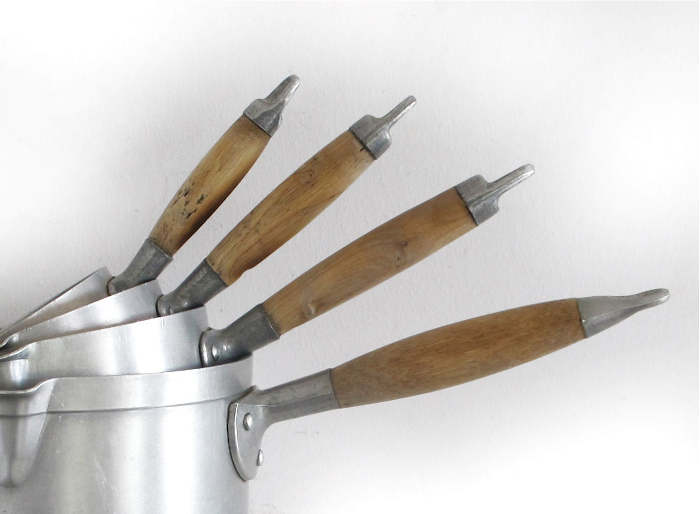 set of 4 French antique metal sauce pans, wooden handle, light patina