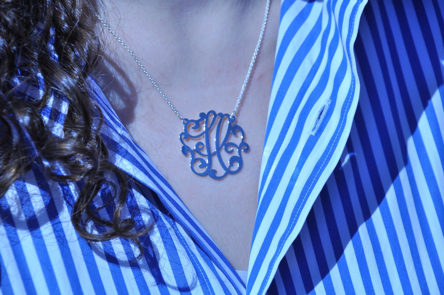 Sterling silver  initial. 1.25" size. with a  chain.
