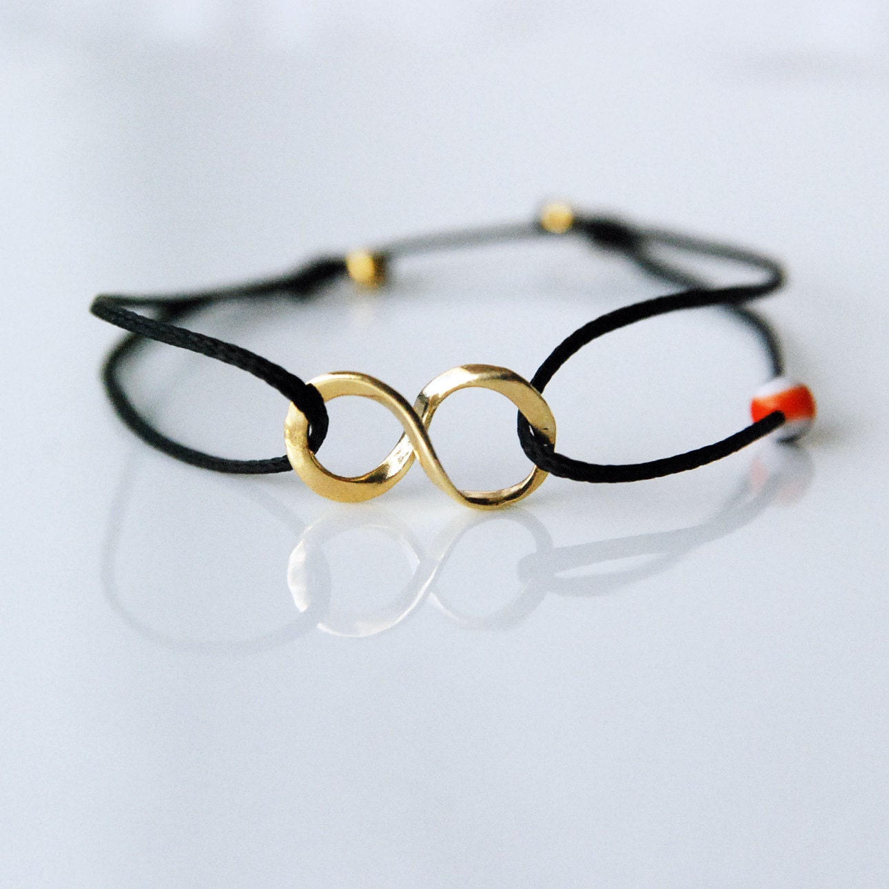 Gold infinity bracelet on black cord, Evil eye bracelet, girlfriend gift