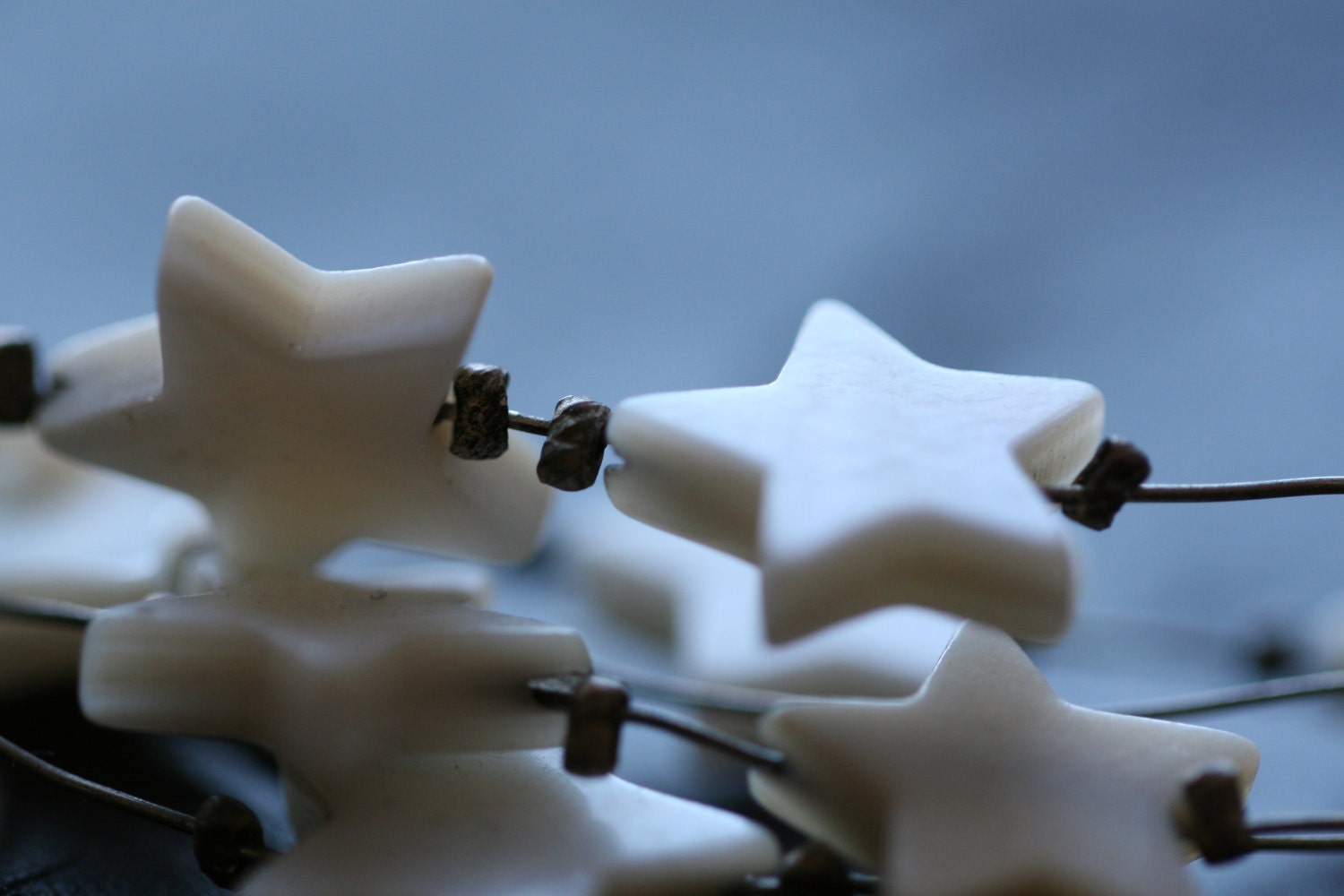 shell star galaxy necklace: dyed shells dotted along an orbital wire necklace
