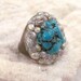 Carved Wood ring Featuring a sea blue turquoise surrounded by fresh pearls