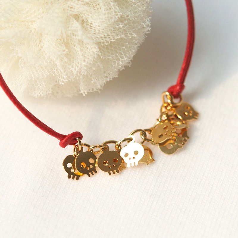 Baby Skull Bracelet -gold plated brass in red cord