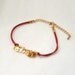 Baby Skull Bracelet -gold plated brass in red cord