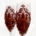 Wedding champagne glasses, toasting flutes with a blood-red damask on a chocolate background