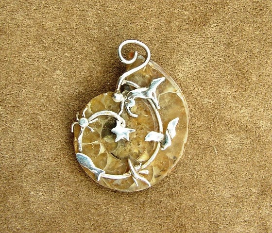Ammonite fossil pendant wrapped in sterling silver