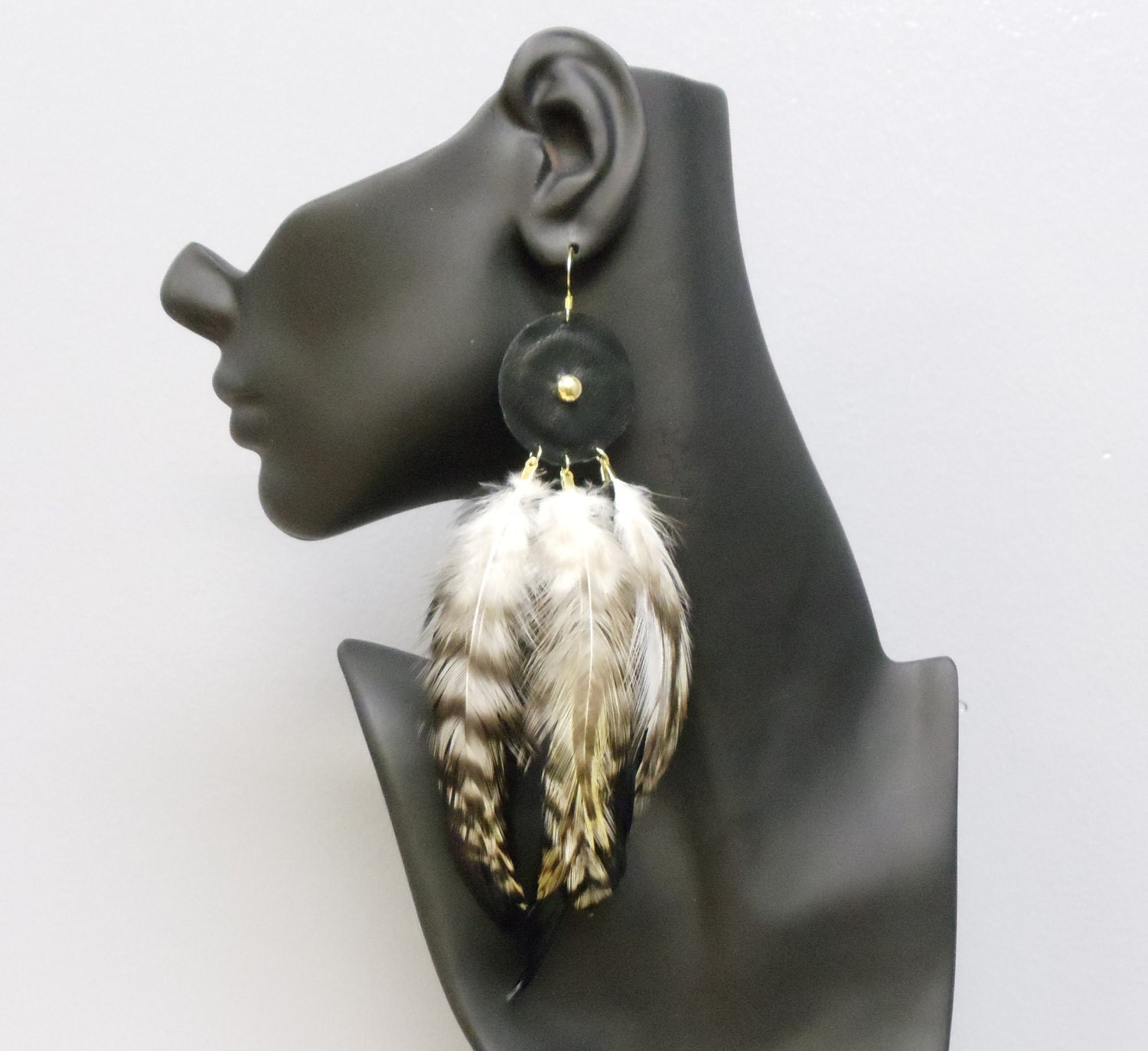 Big gold plated statement feather and leather earrings