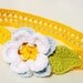 Crochet headband for babies and children in bright yellow, decorated with flower