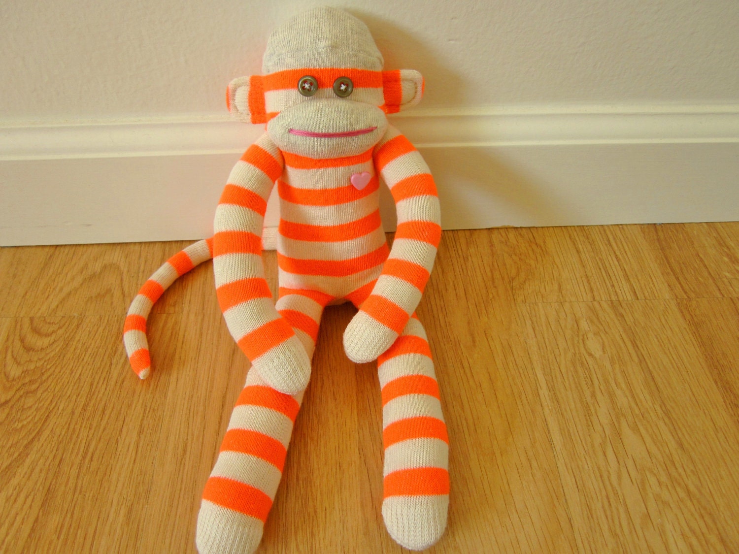 Neon sock monkey plush doll with fluorescent orange and cream stripes