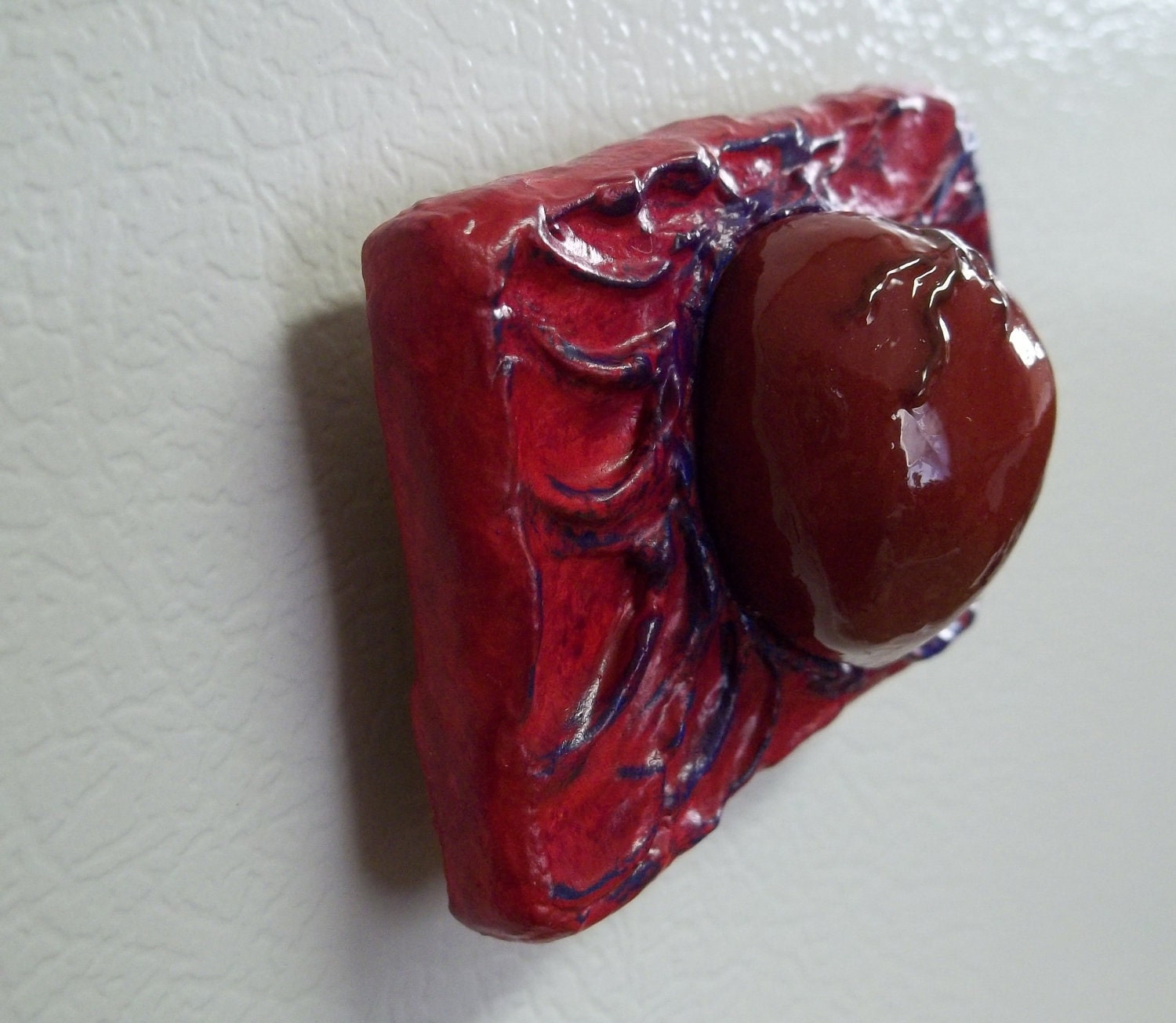 red heart on red, purple, and blue background magnet