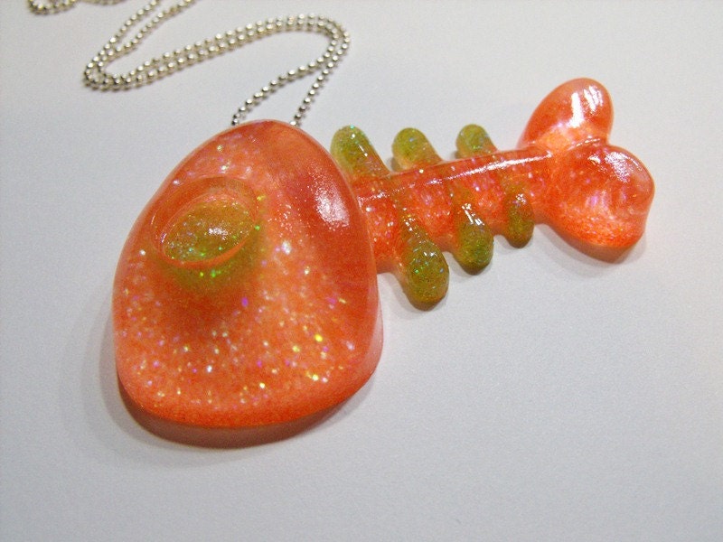 Dead fish resin pendant in neon orange and green