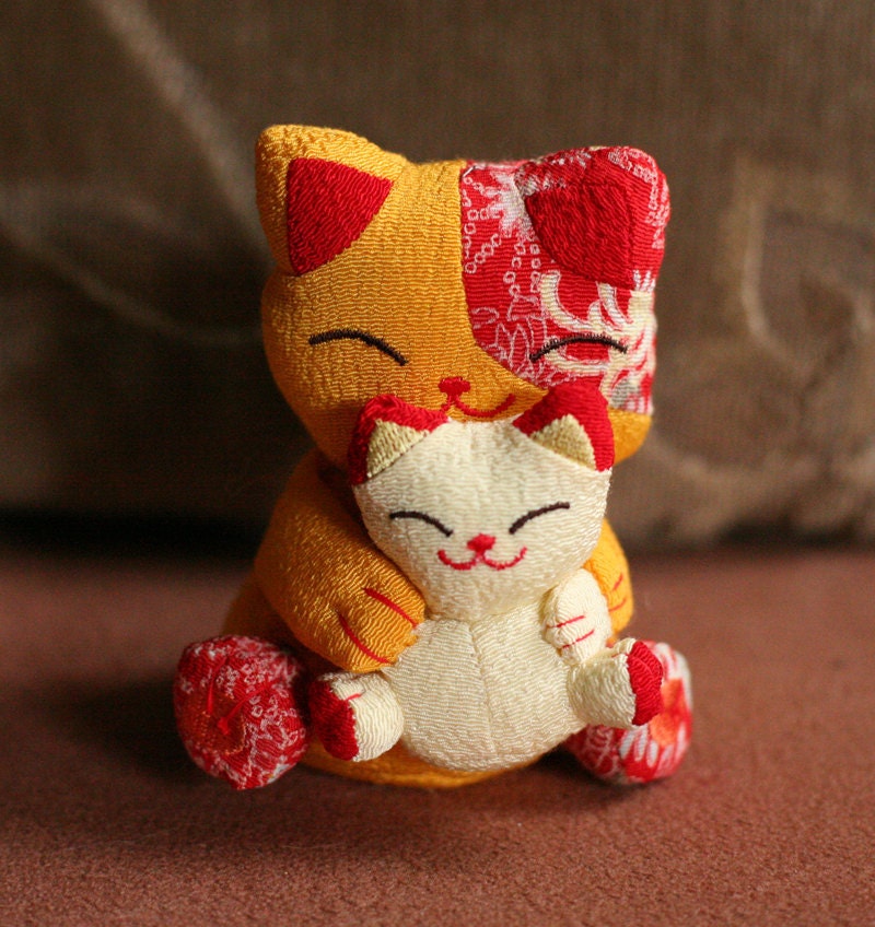 Asian lucky cats - two plush cats hugging
