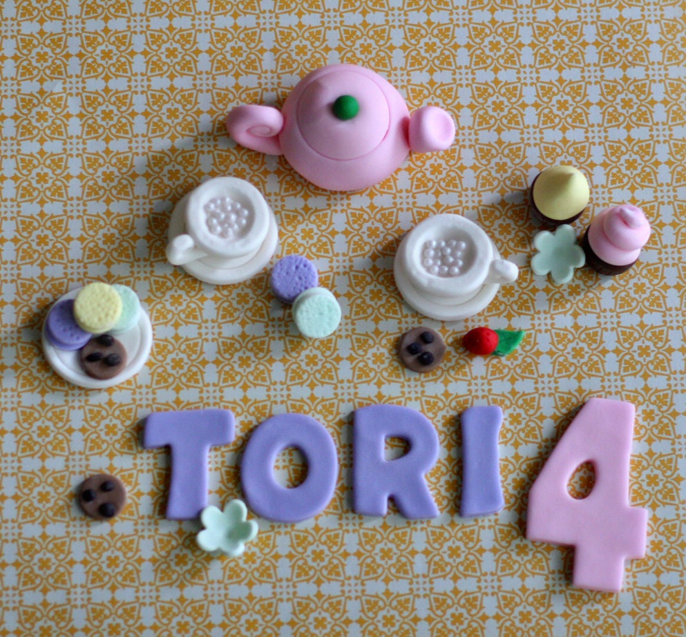 Fondant Tea Set, Tea Cups, Cookies, Cupcakes, Flowers and the Birthday Kid's Name and Age Cake Decorations