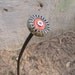Steampunk Found Object Flower - Bullet center, found object. Orange, green, rusty silver