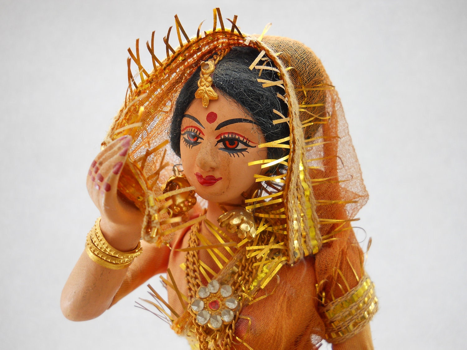 Indian Rani figurine, doll, woman in saffron orange sari