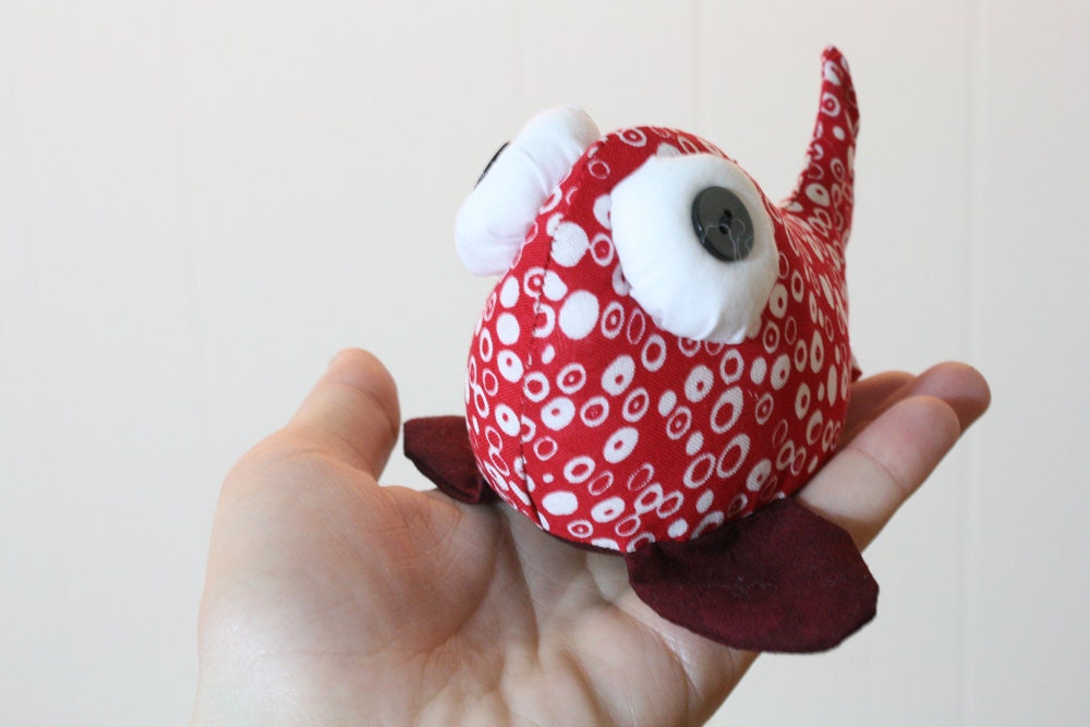 beady-eyed fish in red and white cotton print