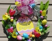Easter Egg home decor filled with tulips and colors of pink, green, purple, yellow, orange all of glitter all on a grapevine wreath 21x20x5
