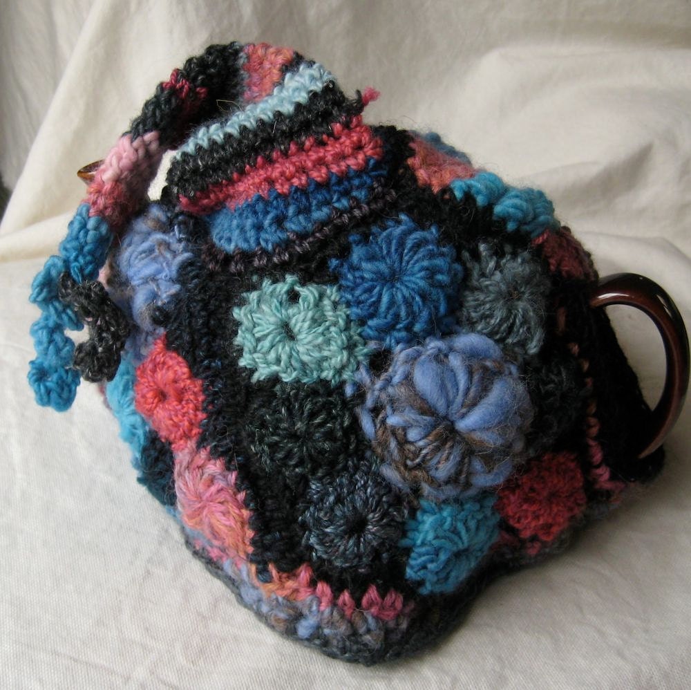 Tea Cozy made in Freeform Crochet and knitting - blue, pink, and charcoal with a hat