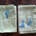 set of 4 light green napkins with teal birds.