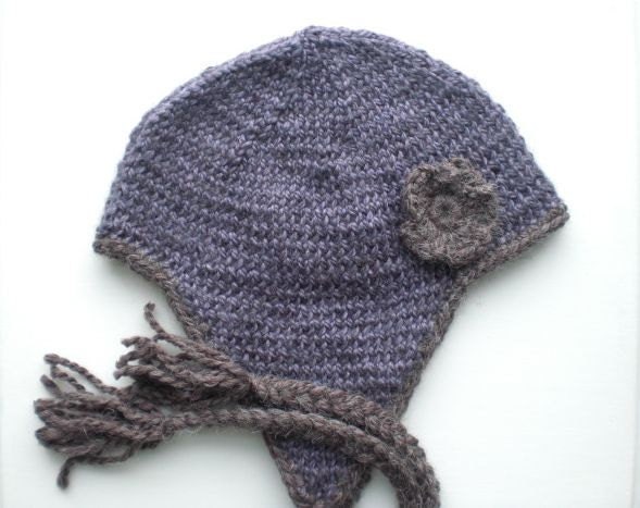 Knitted alpaca helmet. Deep violet purple lavender. Earthy brown trim and flower decoration.